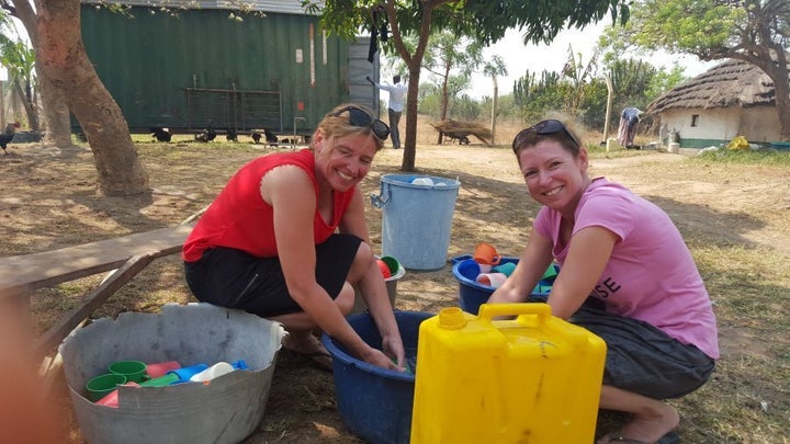 Diane and her sister Julie Lancaster helping out with the dishes while volunteering at Amari Development School in Uganda.