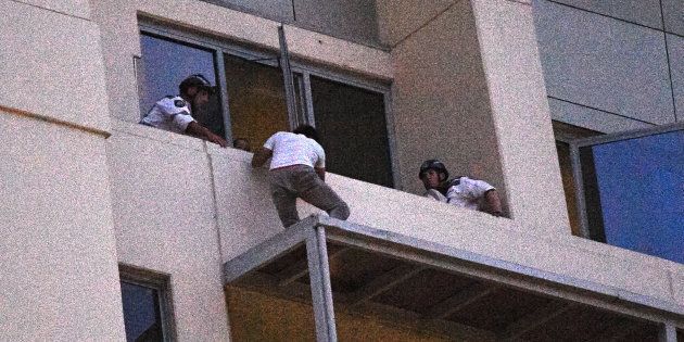 A man who spent the day on an awning on a high rise building in Chatswood gives himself up to Police Rescue members.
