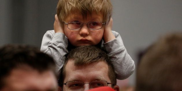 A child covers his ears before Republican presidential nominee Donald Trump appears at a campaign rally in Sioux City, Iowa, U.S. November 6, 2016.