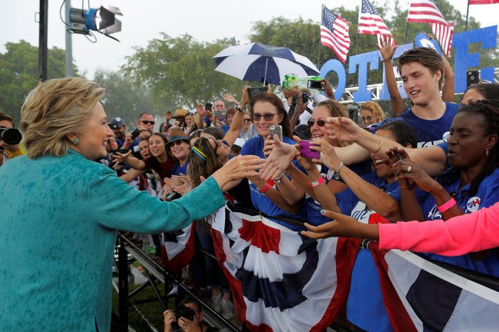 U.S. Democratic presidential nominee Hillary Clinton greets audience members at a campaign rally in the rain in Pembroke Pines, Florida, U.S. November 5, 2016. REUTERS/Brian Snyder