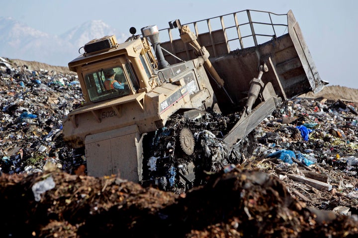 A bulldozer churns through mounds of garbage at the Puente Hills Landfill facility. It is the biggest active landfill in the nation. Every day more than 13,000 tons of garbage is dumped there each year, nearly 4 million tons, about a third of LA County's trash.