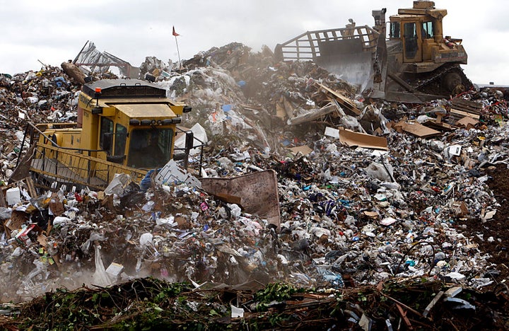 In California, U.S.A heavy equipment operators use machinery to compact and shape mountains of trash at L.A.