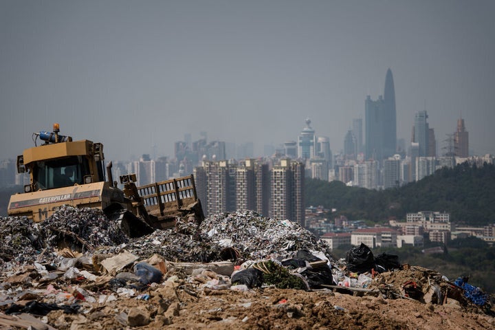 A landfill in the new territories of Hong Kong with the Chinese city of Shenzhen looms in the background.