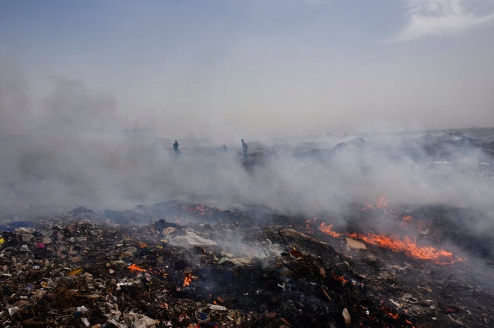 Smoke rising out of fire at Delhi's largest landfill, Bhalswa dump yard, due to soaring temperature in New Delhi, India.