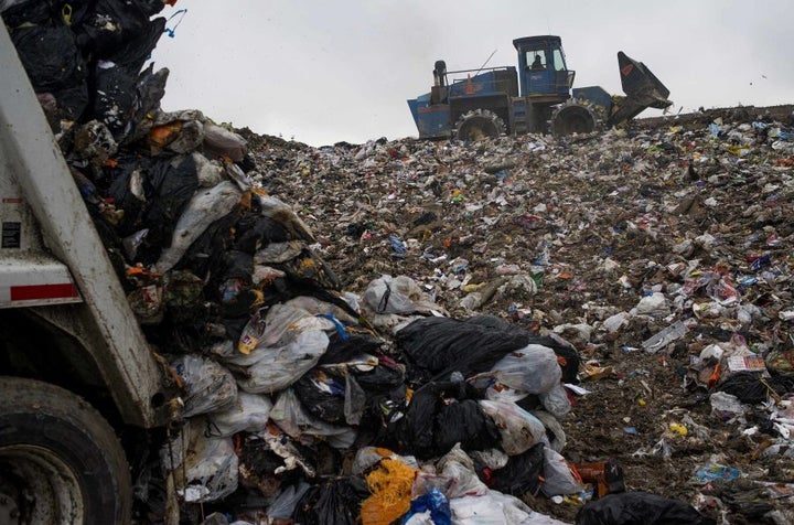 A compactor packs down trash to be covered with fresh dirt at the Defiance County Landfill in Defiance, Ohio, U.S.A.