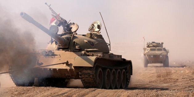 Military vehicles of Kurdish peshmerga forces roll towards Mosul.