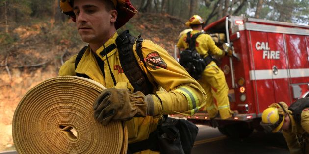 Firefighters work to contain a wildfire outside Calistoga, California, U.S.