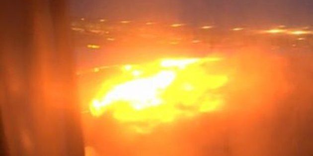 A still image of the plane's wing on fire.