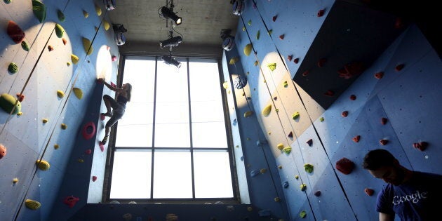 Google employee Dalya Gershtein scales the climbing wall inside the gym of Google's new Canadian engineering headquarters in Ontario in January 2016.