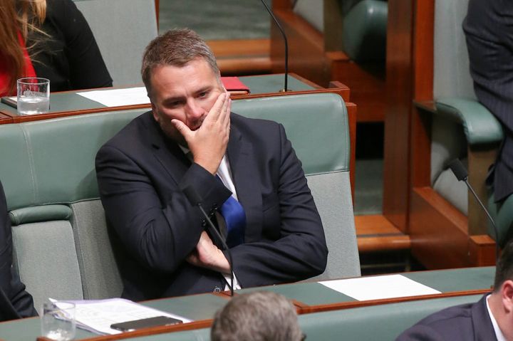 Liberal MP Jamie Briggs takes a seat on the backbench after resigning from the ministry.