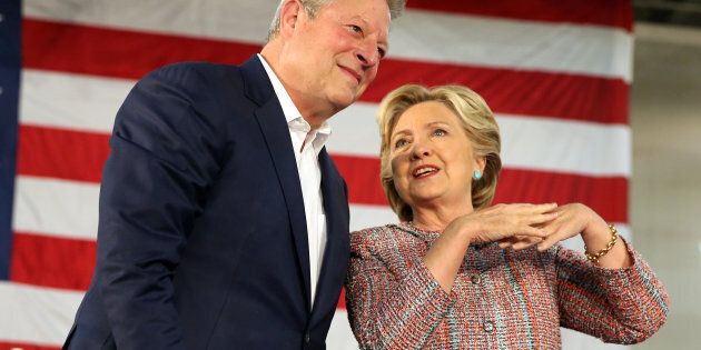 U.S. Democratic presidential nominee Hillary Clinton (R) and former Vice President Al Gore talk about climate change at a rally at Miami Dade College in Miami, Florida, U.S. October 11, 2016. REUTERS/Lucy Nicholson