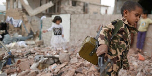 Yemeni officials said triple attacks by Islamic State militants on Monday left 45 dead. Above, a boy carries a toy machine gun next to destroyed houses in Sanaa last week.