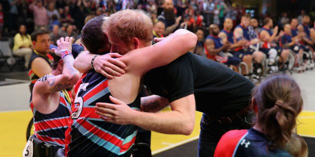 Prince Harry hugs competitors and presents medals during the wheelchair basketball on the final day of the Invictus Games Orlando 2016