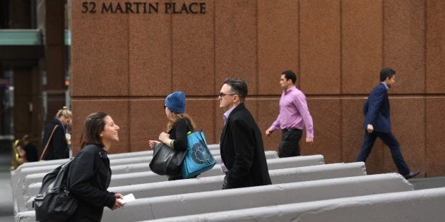 Pedestrians walk past newly-installed concrete security bollards near the Lindt Cafe on July 17, 2017, scene of the 2014 Sydney cafe seige, in which two hostages and the gunman were killed.