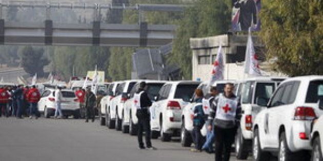 A convoy consisting of Red Cross, Red Crescent and United Nation (UN) gather before heading towards to Madaya from Damascus, and to al Foua and Kefraya in Idlib province, Syria January 11, 2016. Aid convoys headed for a besieged Syrian town where thousands are trapped and the United Nations says people are reported to have died of starvation. Trucks headed for Madaya, near the Lebanese border, and two villages in the northwest of the country on Monday, the Red Cross said, as part of an agreement between warring sides. REUTERS/Omar Sanadiki TPX IMAGES OF THE DAY