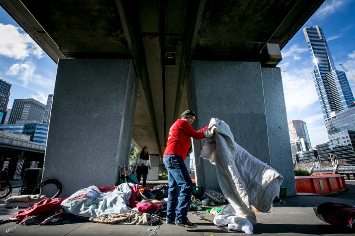 The Melbourne City Council and Police move homeless people and their belongings away from the Enterprize Park.