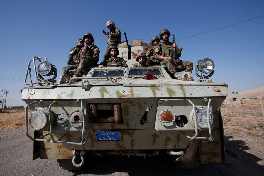 Syrian Kurdish fighters ride a military vehicle in the town of Bashiqa, after it was recaptured from the Islamic State, east of Mosul, Iraq, November 12, 2016.