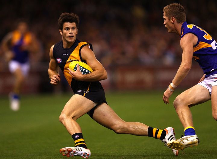 Cotchin in 2012, also eluding an Eagles player.