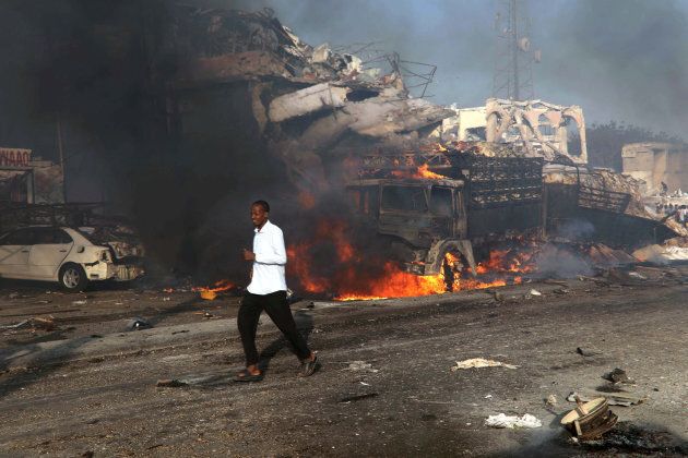 A man runs past the scene of an explosion in Mogadishu, Somalia October 14, 2017. REUTERS/Feisal Omar