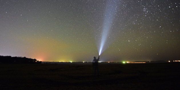 Meteors streak across the night sky during the Orionid meteor shower.