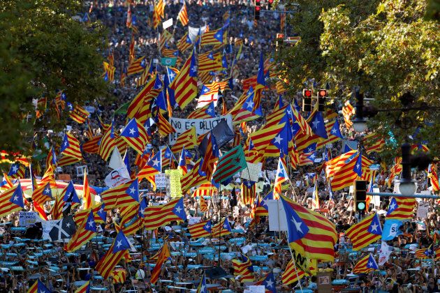 People wave Catalan separatist flags during a demonstration organised by Catalan pro-independence movements in Barcelona.