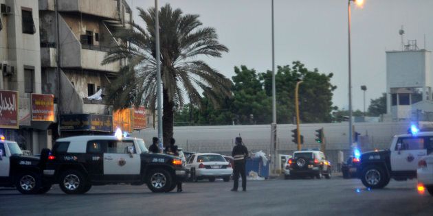 Saudi policemen stand guard at the site where a suicide bomber blew himself up in the near the American consulate in Jeddah.