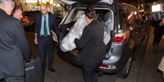 AFP officers load bags of shredded documents into a van during a raid on AWU offices on Tuesday.