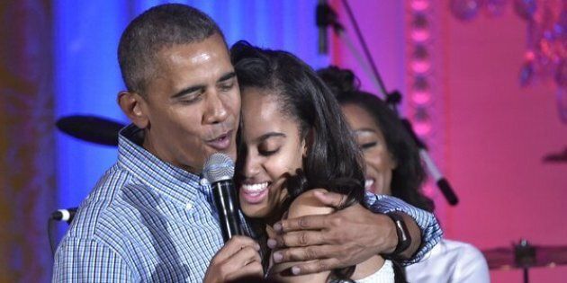 US President Barack Obama hugs his daughter Malia on her birthday during an Independence Day Celebration for military members and administration staff on July 4, 2016 in the East Room of the White House in Washington, DC. / AFP / Mandel Ngan (Photo credit should read MANDEL NGAN/AFP/Getty Images)