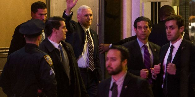 Vice President-elect Mike Pence, top center, leaves the Richard Rodgers Theatre after a performance of