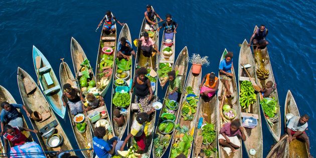 A boat market visits a cruise ship in the Solomon Islands.