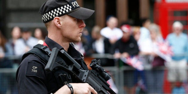 An armed police officer patrols ahead of the arrival of members of Britain's royal family to a service of thanksgiving for Queen Elizabeth's 90th birthday at St Paul's cathedral in London, Britain, June 10, 2016. REUTERS/Peter Nicholls