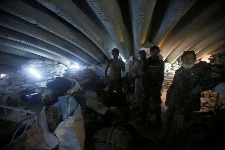 Members of the Shi'ite Badr Organisation fighters inspect a tunnel used by Islamic State militants during a battle with Islamic State at the airport of Tal Afar west of Mosul, Iraq, on November 20