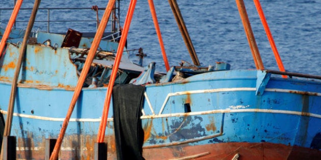 The wreck of a fishing boat that sank in April 2015, drowning hundreds of migrants packed on board, is seen after being raised in the Sicilian harbour of Augusta, Italy, July 1, 2016. REUTERS/Antonio Parrinello/File Photo