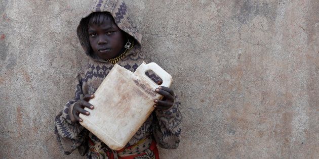 A Turkana girl holds a canister as she waits to get water from a borehole near Baragoy, Kenya, in February.