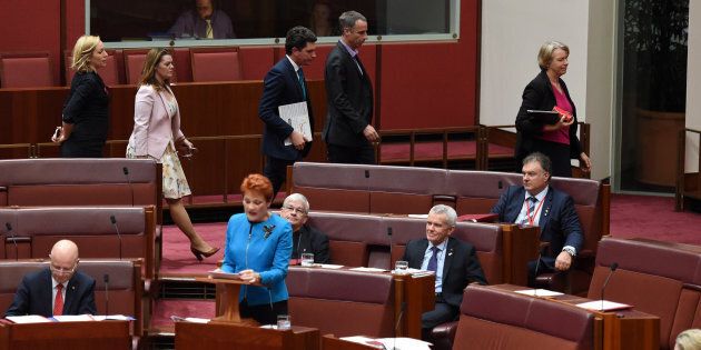 Green Party senators walk out as Australia's One Nation party leader Senator Pauline Hanson (C) makes her maiden speech in the Senate at Parliament House in Canberra, Australia, September 14, 2016.