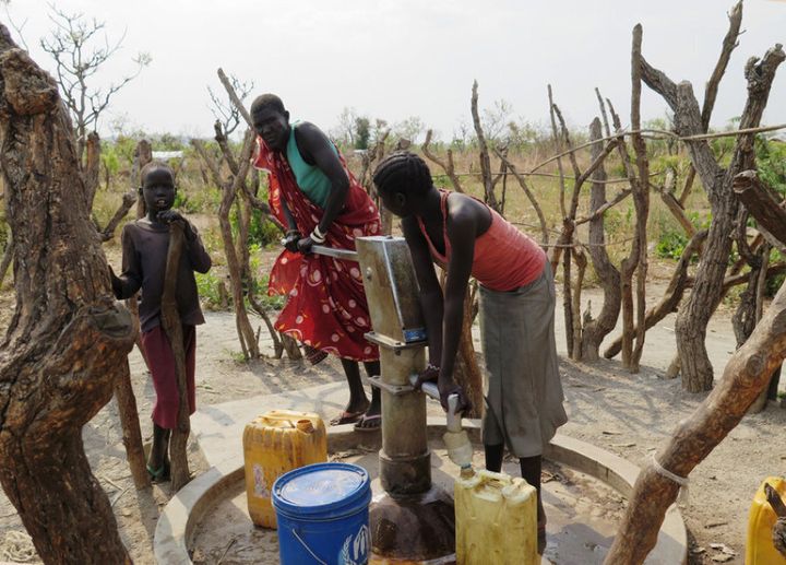 Children pump water from a borehole drilled by Plan International at Melijo camp.