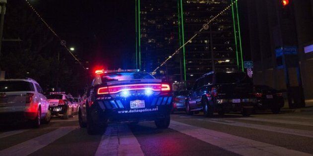 Police cars sit on Main Street in Dallas following the sniper shooting during a protest on July 7, 2016. A fourth police officer was killed and two suspected snipers were in custody after a protest late Thursday against police brutality in Dallas, authorities said. One suspect had turned himself in and another who was in a shootout with SWAT officers was also in custody, the Dallas Police Department tweeted. / AFP / Laura Buckman (Photo credit should read LAURA BUCKMAN/AFP/Getty Images)