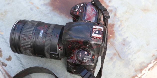 The blood stained camera of a photojournalist is seen in front of Dayah hotel in Somalia's capital Mogadishu, on Jan. 25.