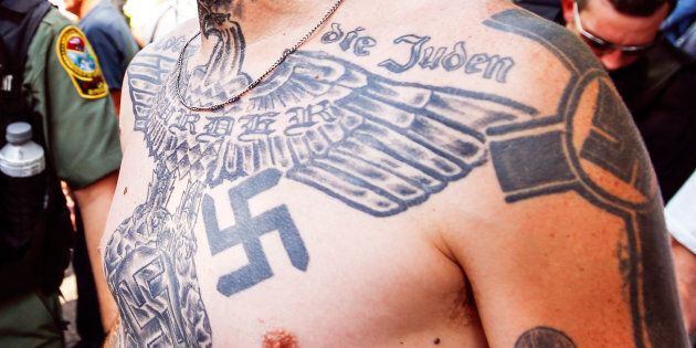 A supporter of the Ku Klux Klan is seen with his tattoos during a rally at the statehouse in Columbia, South Carolina July 18, 2015.