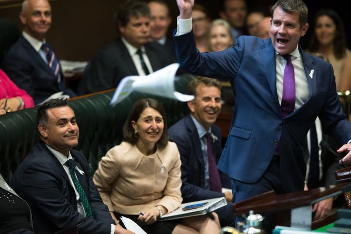 The new Deputy Premier, John Barilaro, watches Premier Mike Baird throw some papers across the room in parliament after he was appointed the NSW Nationals leader, in Sydney.