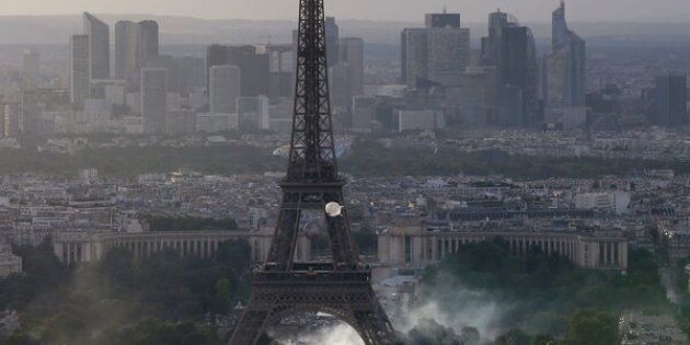 TOPSHOT - A picture taken from the Tour Montparnasse shows tear gas under the Eiffel tower during clashes between police and supporters trying to illegally enter the Champs de Mars fan zone on July 10, 2016 in Paris, before the Euro 2016 football tournament final match between Portugal and France. / AFP / Thomas SAMSON (Photo credit should read THOMAS SAMSON/AFP/Getty Images)