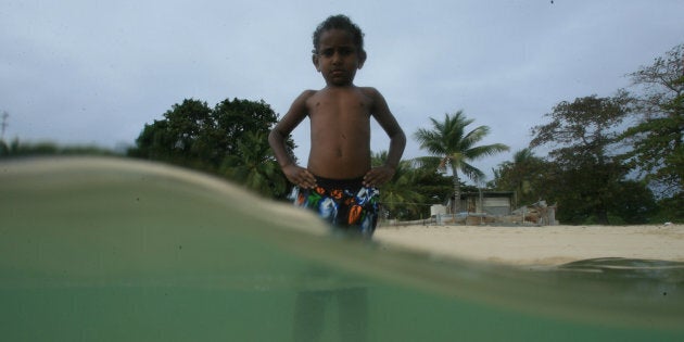 August, 9 2006: Ngukis Abednego of Masig Island in the Torres Strait swims during high tide. There has been flooding on several islands generating concerns about climate change and rising sea levels.