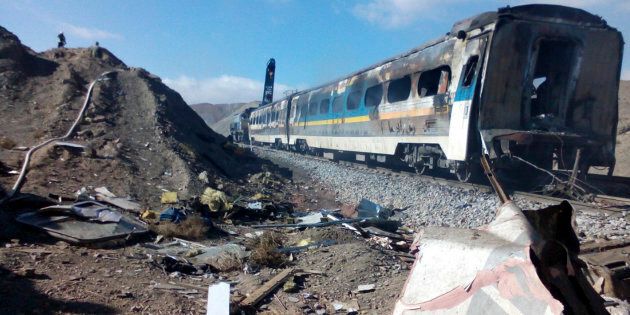 This picture released by Iranian Fars News Agency shows the scene of two trains collision about 150 miles (250 kilometers) east of the capital Tehran, Iran, Friday, Nov. 25, 2016. An Iranian official has told state TV that the death toll from a train collision in the country's north has increased to 31. The provincial governor, Mohammad Reza Khabbaz, says that so far 31 bodies have been found at the site of the crash on Friday morning. (Saeed Esmaeilpour, Fars News Agency via AP)