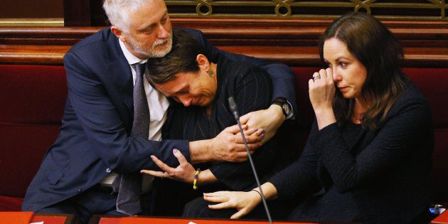 Labor MP Jaala Pulford is hugged by Gavin Jennings MP while crying after speaking about the loss of her daughter.