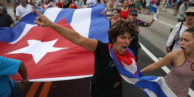 Cuban Americans celebrate upon hearing about the death of longtime Cuban leader Fidel Castro in the Little Havana neighborhood of Miami, Florida on November 26, 2016. Cuba's socialist icon and father of his country's revolution Fidel Castro died on November 25 aged 90, after defying the US during a half-century of ironclad rule and surviving the eclipse of global communism. / AFP / RHONA WISE (Photo credit should read RHONA WISE/AFP/Getty Images)