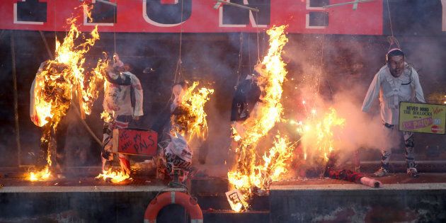 A collection of punk memorabilia belonging to Joe Corre, the son of Malcolm McLaren, the former manager of the Sex Pistols and fashion designer Vivienne Westwood, is burnt on a boat on the River Thames, in London, Britain November 26, 2016. A collection of punk music memorabilia went up in flames on Saturday in a protest meant to highlight how the genre has been subsumed into the cultural establishment. Joe Corre set fire to his collection - which he valued at 5 million pounds - of punk-era clothes and paraphernalia from the side of a boat on the River Thames, London. Corre organised the protest to oppose a year-long festival called Punk London created to celebrate 40 years of punk culture, supported by establishment bodies like the Mayor of London, the British Council and major record label Universal Music. REUTERS/Neil Hall