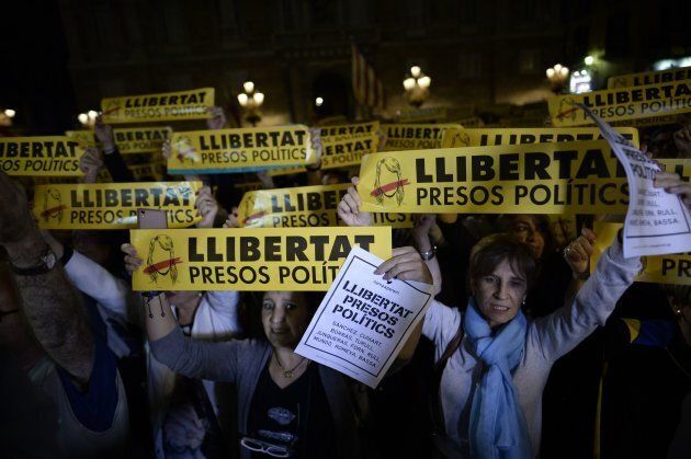 Protesters hold signs reading 'Freedom to political prisoners' during a demonstration in Barcelona.