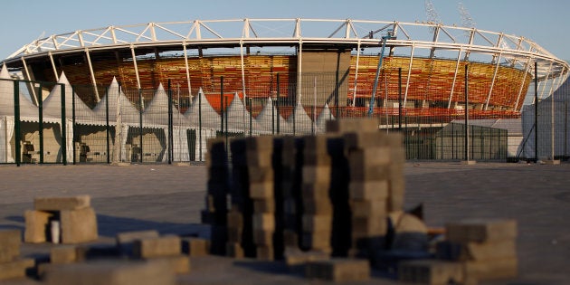 Workers are pictured in the tennis venue at the 2016 Rio Olympics Park in Rio de Janeiro, Brazil, July 11, 2016. REUTERS/Bruno Kelly