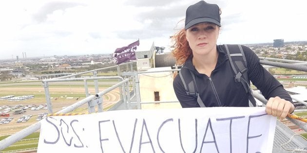 One of the protesters atop the crane above Flemington on Melbourne Cup day