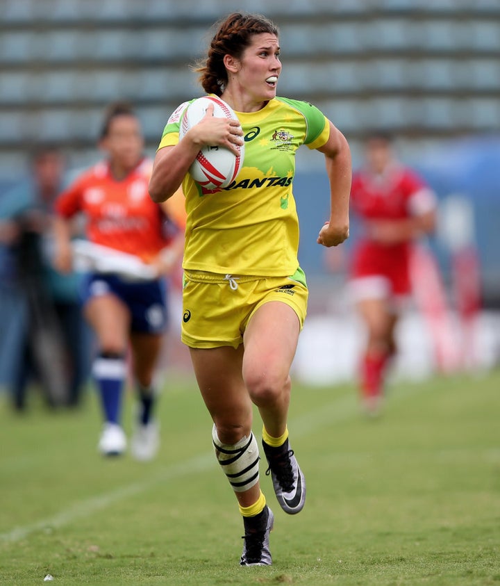 Rugby Sevens player Charlotte Caslick and her partner Lewis Holland pose  for a photograph at the 